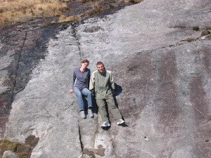 Wala and Matteo sitting on a rock in Wicklow